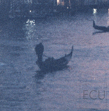 Color photograph of a gondolier on the Grand Canal at dusk in Venice, Italy rendered in an impressionistic style
