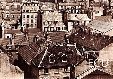 Black and white photo of the rooftops of the Marais section of Paris on right bank taken from rue St. Antoine in Paris, France