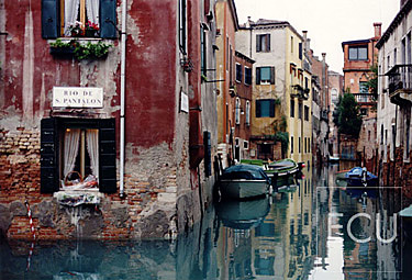 Color photo of a classic venetian canal Munehette next to the Scuolo Grande di San Rocco in the San Polo sestiere of Venice, Italy