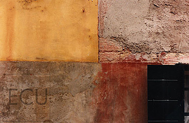 Color photograph of a modern, Venetian wall in yellow, red, black and brown