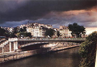 Color photograph of the Seine and the Pont au Double linking Cit&eacute; and the Left Bank as a storm moved in over Paris, France