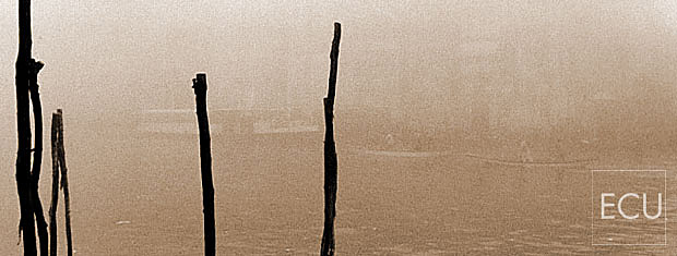 Color photo of the Grand Canal in Venice, Italy in winter in fog with Vaporettos