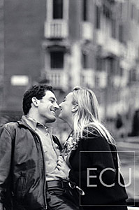 Black and white photos of Vanessa and Mauro on the vaporetto stop of San Toma on the Grand Canal in Venice, Italy